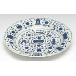 A Worcester The Hundred Antiques pattern shaped circular plate, painted in cobalt blue with