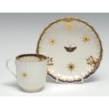 A Worcester fluted coffee cup and saucer, painted in blue and gilt with stars and leaves, the saucer