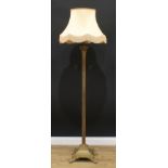 Interior Design - a brass standard lamp, as a Corinthian column, stepped square base, paw feet,