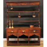 A George III oak pot-board dresser, moulded cornice above a pair of plate rack shelves, the