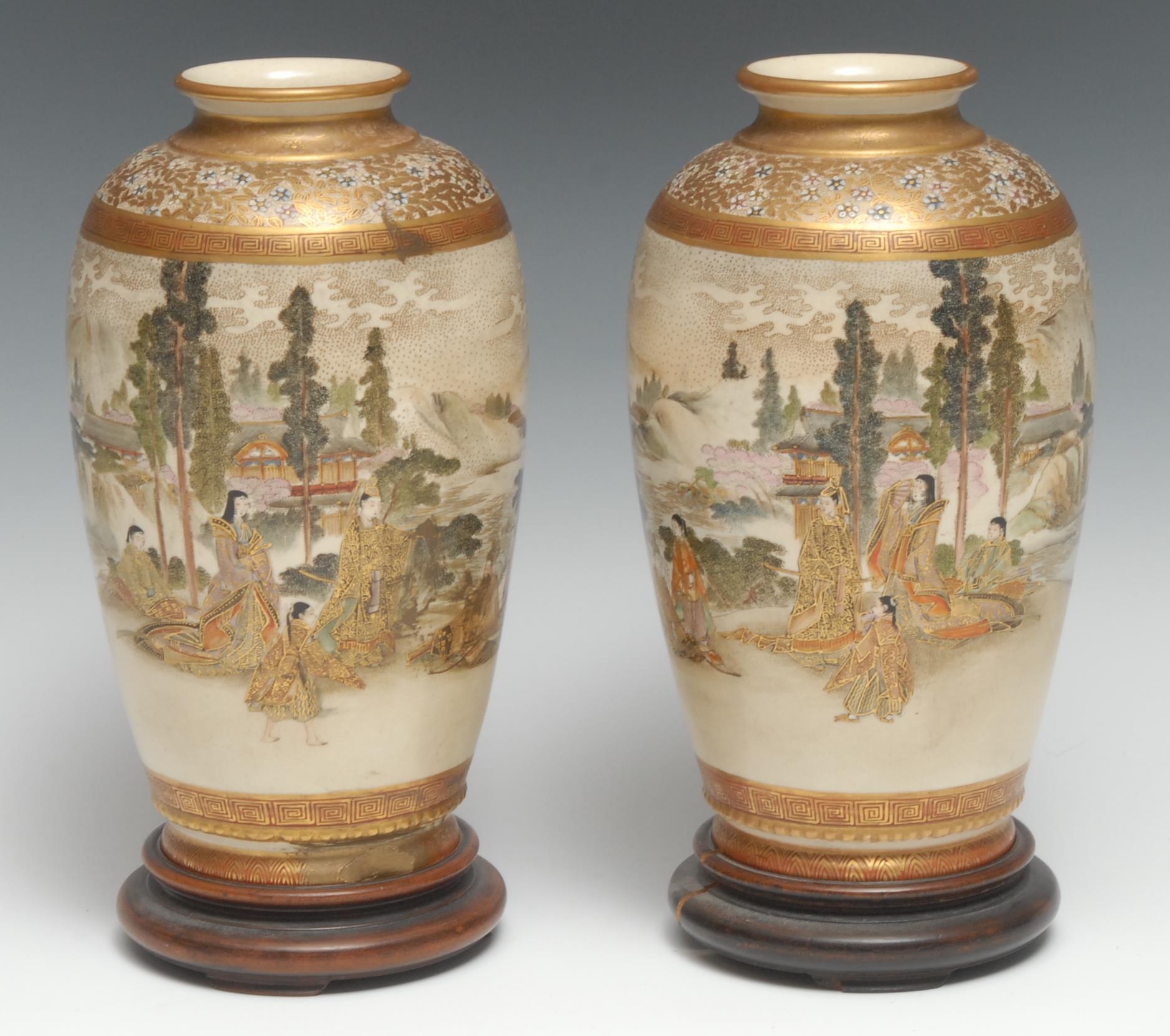 A pair of Japanese Satsuma vases, decorated with a continuous scene of figures in a landscape, 19.