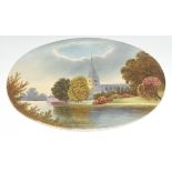 An English Pottery oval ceramic plaque, painted with a view of a cathedral by river, 33cm wide, c.