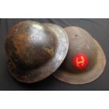 WW1 US Army issue steel helmet shells x 2. One with camo paint and the other with hand painted