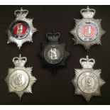 A collection of 5 ERII Warwickshire Constabulary Helmet Plates; one night plate, two enameled plates