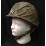 US M1 Steel Helmet complete with liner and 1980's Woodland Pattern Camo cover to which is pinned and