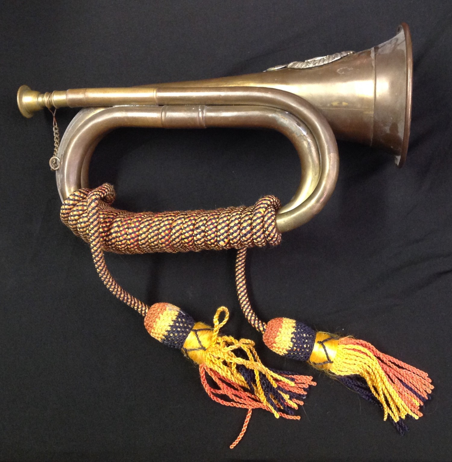 Brass and Copper Bugle complete with cords with a Rifle Brigade cap badge affixed.