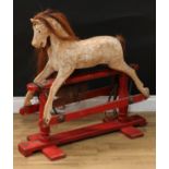 An early 20th century Lines Brothers rocking horse of small proportions, the stripped and carved