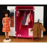 A 1960's Sindy doll, dark brunette bubble shaped hair, side glancing blue eyes, wearing a