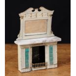 A late 19th century German dolls house fireplace with over mantle mirror, painted tinplate