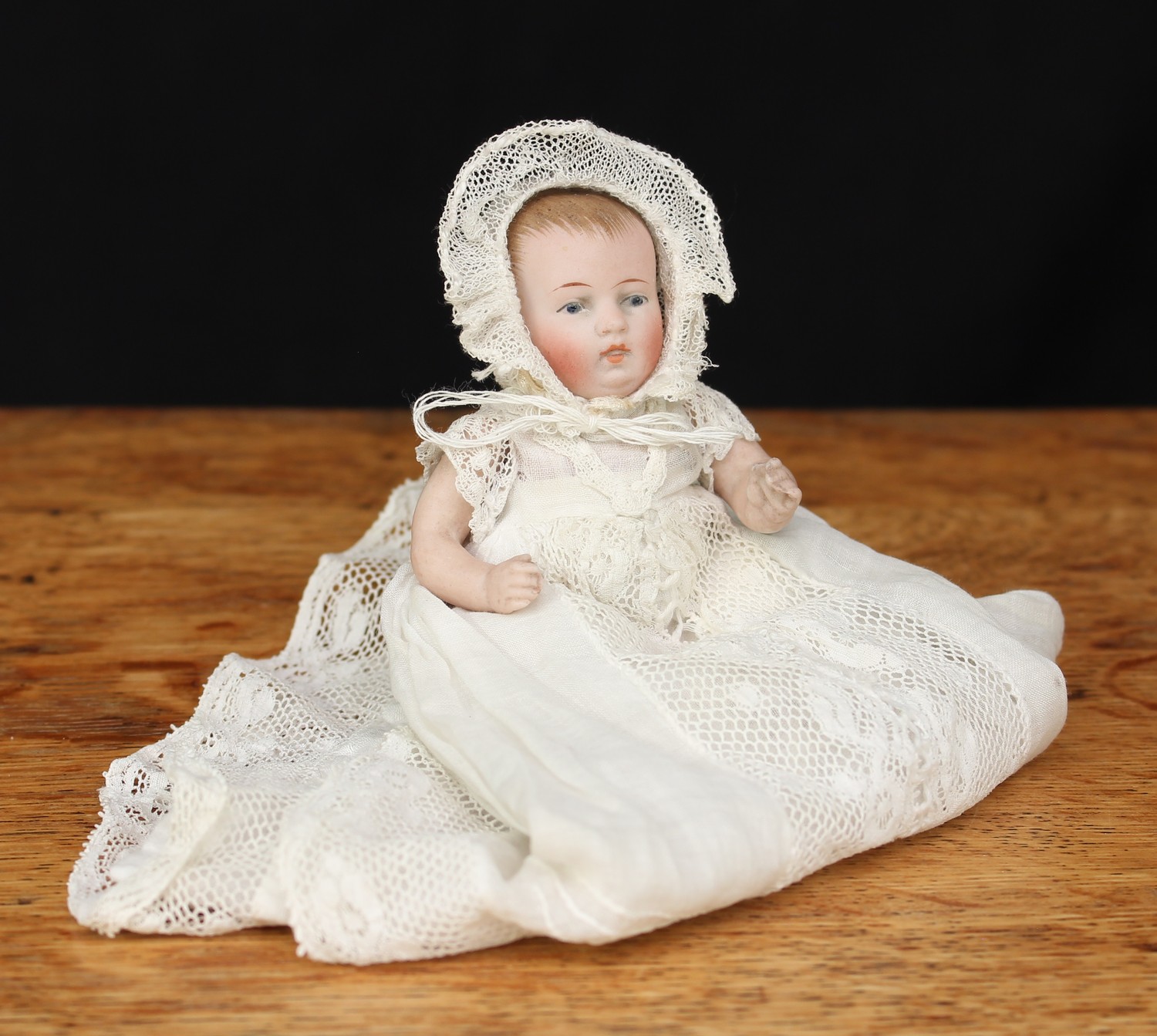 A German all bisque jointed miniature character baby doll, painted blue glass eyes and features
