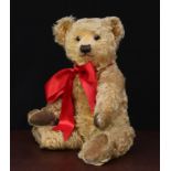 A 1930's Chiltern golden mohair jointed teddy bear, glass eyes with remains of brown painted