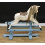 An early 20th century English rocking horse on safety stand, the carved, gesso and white painted