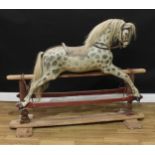 A large and substantial mid to late 19th century rocking horse on safety stand, attributed to Paul