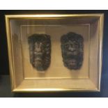 Two Victorian carved oak lion's masks, cased