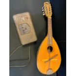 A Tantra Neapolitan bow back mandolin, 61cm long; a Regentone type W1A portable radio, pierced metal