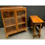 A 20th century mahogany two door display cabinet, 121cm high, 92cm wide, 32.5cm deep; a drop leaf