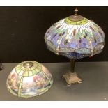 A Tiffany style dragonfly table lamp, leaded shade in tones of blue, green, purple and white,