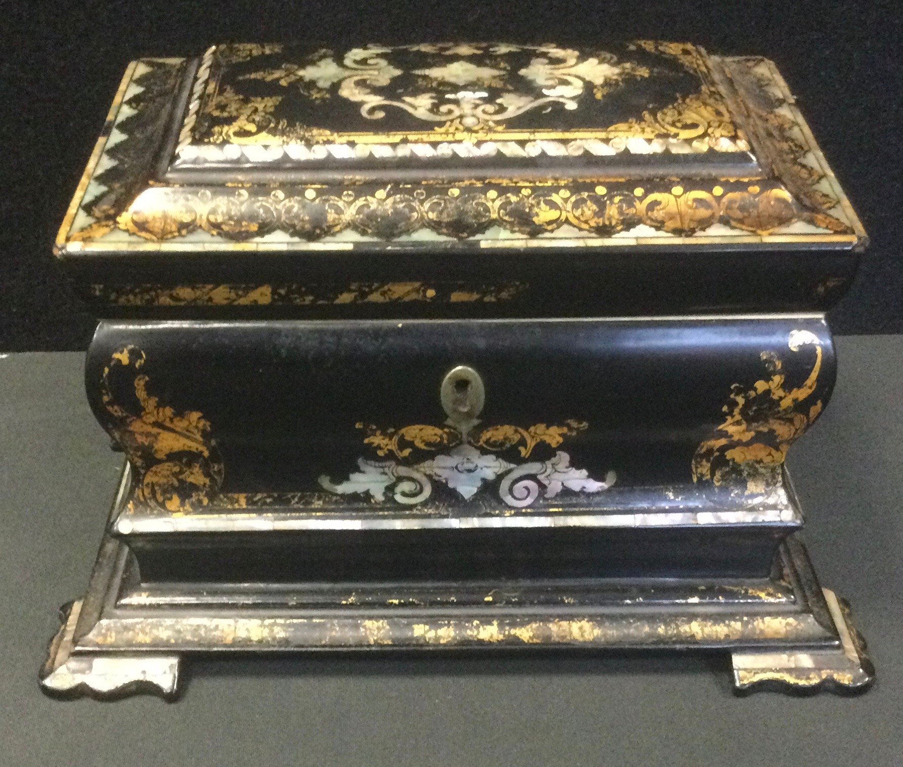 A Victorian papier mache tea caddy, inlaid in abalone and mother-of-pearl, 15cm high, c.1860