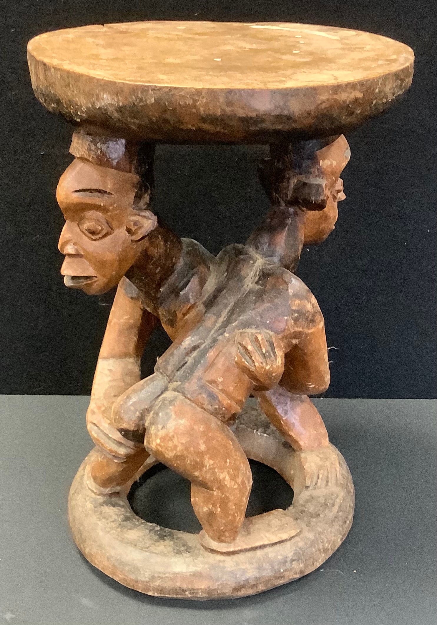 A North African Wrestling Stool ,possibly Cameroon, 43cm high, 29cm diameter.