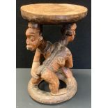 A North African Wrestling Stool ,possibly Cameroon, 43cm high, 29cm diameter.