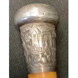 A late 19th century Chinese walking cane, silver coloured metal pommel embossed with oriental