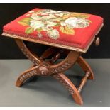 A Victorian adjustable rectangular stool, tapestry top,X frame carved with roundels, 45cm high, c.