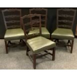 A set of four early 20th century mahogany dining chairs, pierced ladder back splats, leather