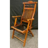 An early 20th century campaign chair, with slatted back, brass studded seat, c.1900