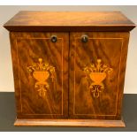 A 19th century walnut rectangular cabinet, inlaid with flowering urns skirted base, the interior