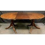 A 19th century mahogany twin pillar D-end dining table, urnular pillars, brass paw form casters,