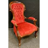 A Victorian mahogany side chair, deep buttoned back, carved cresting rail, cabriole legs, knurl fee,