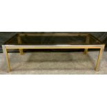 A contemporary smoked glass and gilt metal rectangular coffee table, 41cm high, 130cm wide.