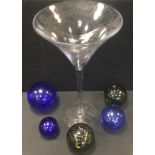 Three blue glass Witches balls; others green; a large clear glass glass, 55cm high
