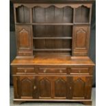 A late 19th century oak dresser, top comprising plate rack flanked by a pair of cupboards over two