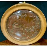 A 19th century coppered metal circular plaque, in relief with Roman figures and buildings, 18cm