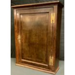 An early 19th century oak rectangular wall cabinet, fielded panelled door, H hinges, 79cm high, 59cm