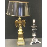 A gilt metal side light, the column with eagle, 54cm high; another, silver plated, 34cm high (2)