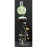 A modern bronzed oil lamp, green etched shade, mottled resevoir, the cast stand with sinuous