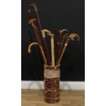 A cylindrical stoneware stick stand; assorted rustic root and branch walking sticks; others; qty