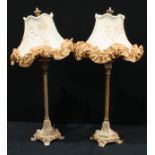 A pair of decorative side lights, with embroidered shades, fluted columns, leafy bases, with