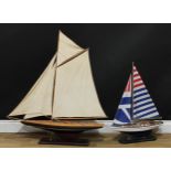 Model Sailing - a wooden model of a sailing yacht, 100cm over base; another, smaller, 71cm over base