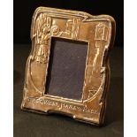 An Elizabeth II silver novelty easel photograph frame, East West, Home's Best, 15.5cm high, London