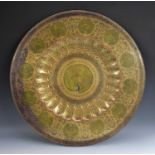 A large Indian brass charger, engraved and decorated in polychrome with peacocks, ropetwist