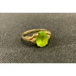 A peridot and diamond chip dress ring, 9ct gold shank, 2.7g