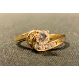A contemporary modernist design diamond twist ring, round brilliant cut diamond approx 0.33ct,