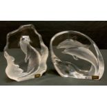 Mats Jonasson; a pair of glass paperweights/sculptures, standing otter and leaping dolphins,