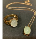 A 9ct gold chatoyant quartz cabochon dress ring, size R, 6.4g gross; a similar pendant necklace, 2.