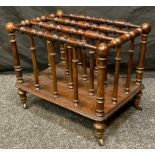 A late Victorian mahogany four section Canterbury, turned divisions and supports, casters, 39cm