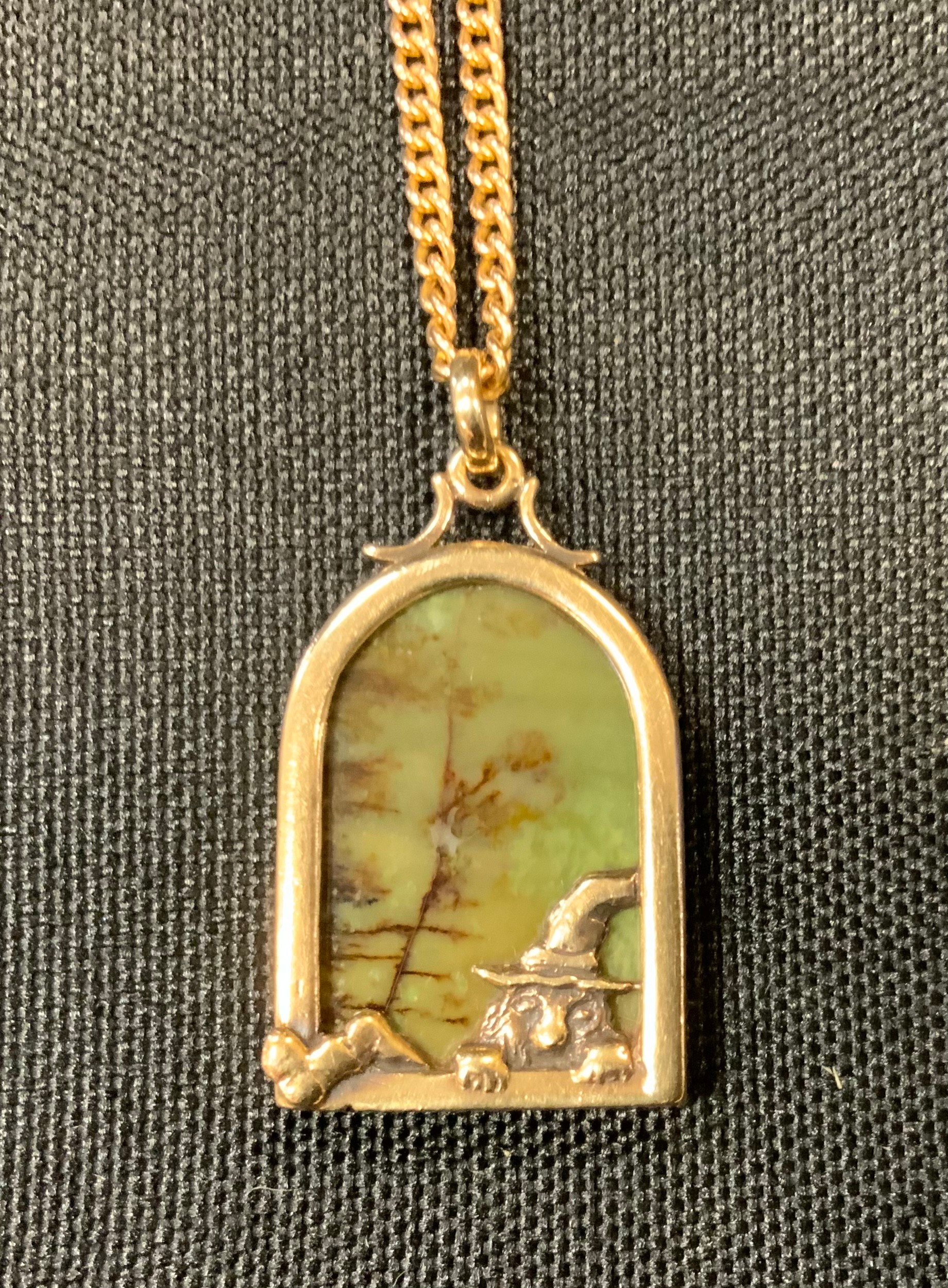 An unusual multi tone stone, possibly agate, pendant as a leprachaun climbing through a window,