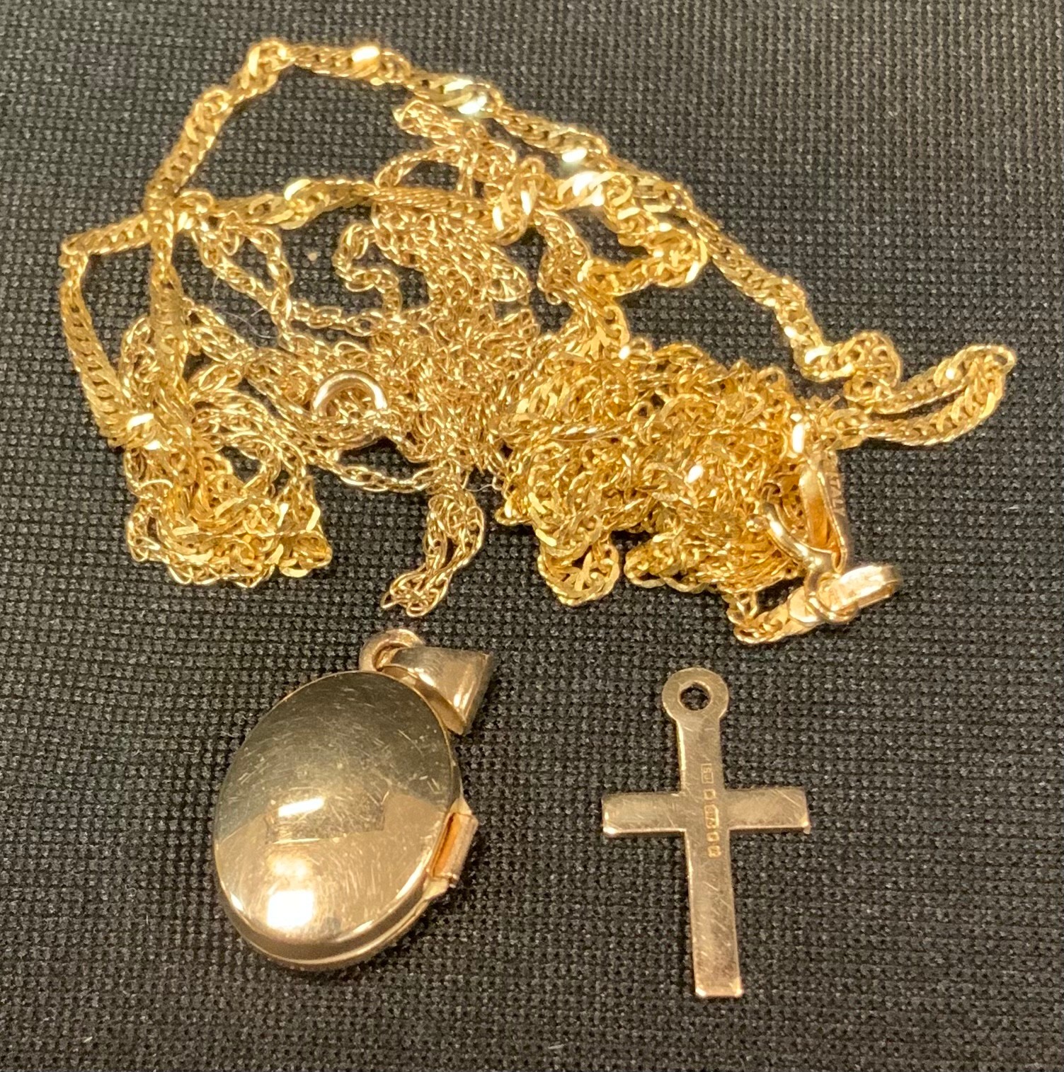 A 9ct gold chain; another; a 9ct cross; etc , 3g